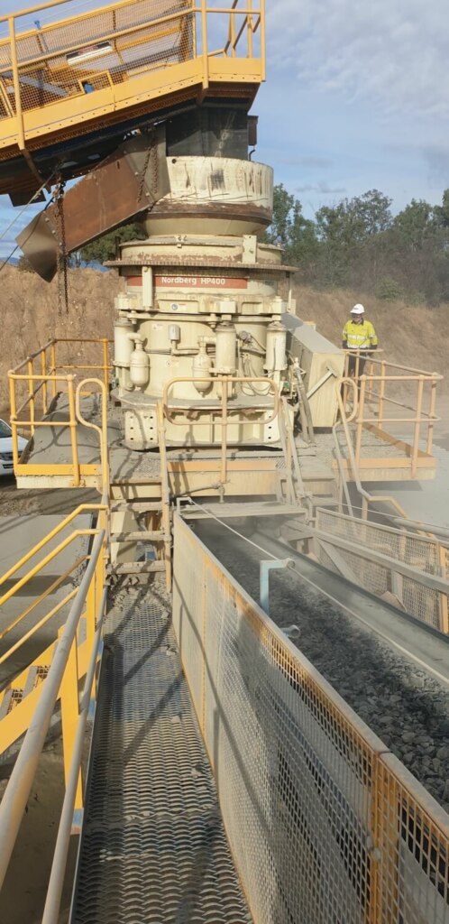 An engineering marvel, this large machine features a conveyor belt attached to it.