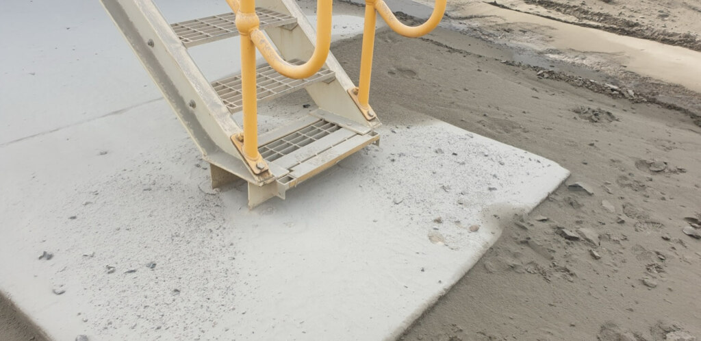 A stylish yellow ladder on the side of a sand dune, showcasing great engineering.